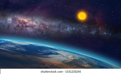 View of the planet Earth from space during a sunrise against milkyway galaxy and sun