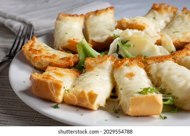 A View Of A Plate Of Cheesy Garlic Bread.