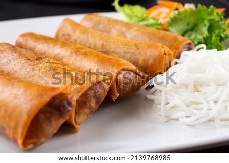 A view of a plate of egg rolls.