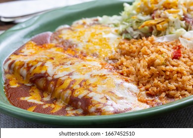 A view of a plate of enchiladas in a restaurant or kitchen setting.