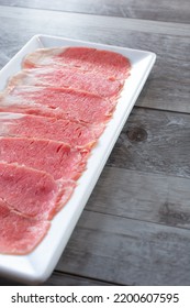 A View Of A Plate Of Raw Beef Brisket Slices.