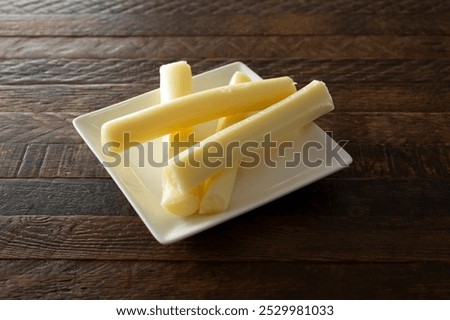 A view of a plate of string cheese.