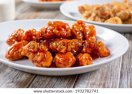 A view of a plate of sweet glazed boneless chicken wings.