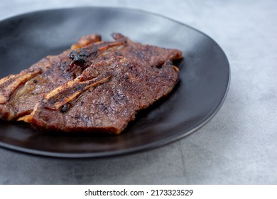 A View Of A Plate Of Teriyaki Pork Short Ribs.