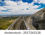 View from the platform built on a massive rock formations with clouds hanging low.