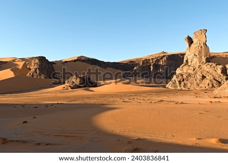 View Playa of Moul Naga, of the Tadrart Rouge rocky mountain range in Tassili n Ajjer National Park. Sahara desert, Algeria, Africa.