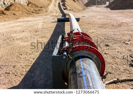 View of the polyethylene pipeline and polyethylene welding machine in the constructine site.