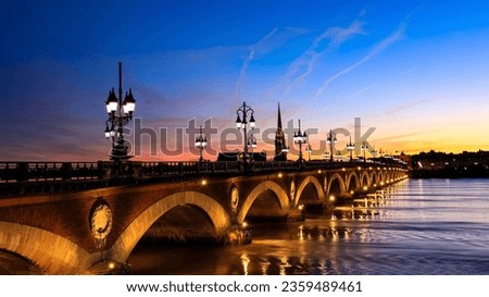 View of the Pont de pierre with sunset sky scene which The Pont de pierre crossing Garonne river	