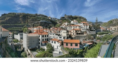View of Ponta do Sol, a small touristic village in the city of Funchal, main avenue facing the sea, with residential buildings, Madeira Island, Portugal