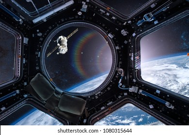 View from a porthole of space station on the Earth background. Elements of this image furnished by NASA.