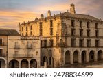 View of the porticoed Palace of the Marquises of the Conquest in the Plaza Mayor of Trujillo, Cáceres, Spain, at dawn