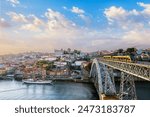 View of Porto city and Douro river and Dom Luis bridge I with tram from famous tourist viewpoint Miradouro do Jardim do Morro on sunset. Porto, Vila Nova de Gaia, Portugal