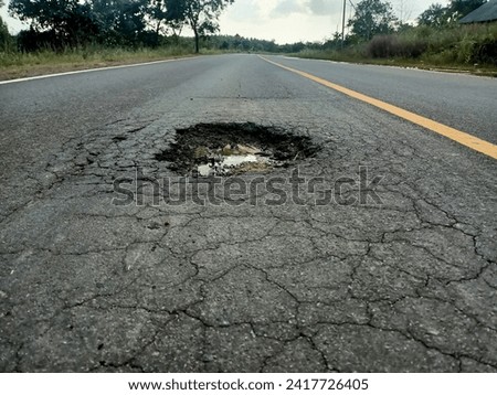 view of a pothole in the middle of the road in the afternoon in Dompak Tanjungpinang