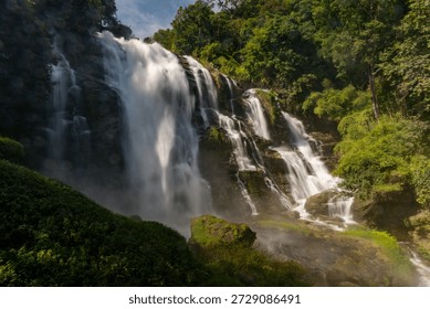 View of a powerful waterfall using slow shutter technique in the midst of a jungle