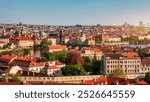 View of Prague featuring vibrant rooftops on a sunny day in summer. Aerial view of Prague, Charles Bridge over Vltava river in Prague, Czechia. Old Town of Prague, Czech Republic.