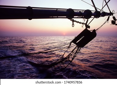 View Of A Prawn Trawler Boom Arm With Otter Boards And Bottom Trawling Nets At Sunset On The Fishing Grounds In The Timor Sea Of The North West Coast Of Darwin