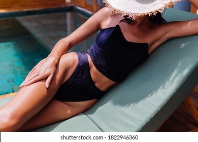 View Of Pretty Tanned Bronze Perfect Skin Woman In Black Vintage Old Bikini Lies On Green Sun Bed At Amazing Villa At Sunny Day, Resting, Enjoying Vacation.