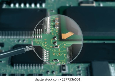 view of printed circuit board with active and passive surface mounted components close up through magnifying glass - Powered by Shutterstock