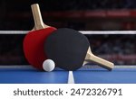 View of professional ping pong set with paddles resting on the net on green game table with white ball. Front view.
