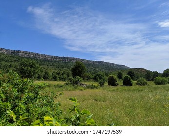 A View Of Provence And The Holy Victory, A Mountain Made Famous By The Painter Paul Cézanne. Beautiful Clouds In The Sky And Grass Field