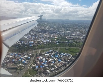 View Of Puerto Rico From Airplane Of Houses With Blue Tarps Due To Damage From Hurricane Maria