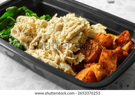 A view of a pulled chicken meal prep entree.