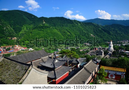 View from the Pusading Temple across the historic village of Wutaishan with its characteristic white pagoda (baita), in Shanxi, China