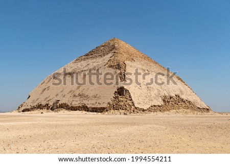 View of Pyramid of Snefru, Bent Pyramid on a blue sky background, at Dahshur, Egypt. The southern pyramid in Dahshur is called cut or diamond-shaped because of its irregular shape.