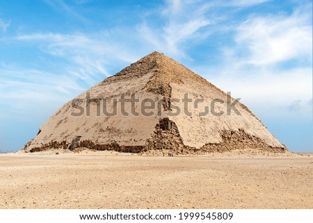 View of Pyramid of Snefru, Bent Pyramid on a blue sky background, at Dahshur, Egypt. The southern pyramid in Dahshur is called cut or diamond-shaped because of its irregular shape.
