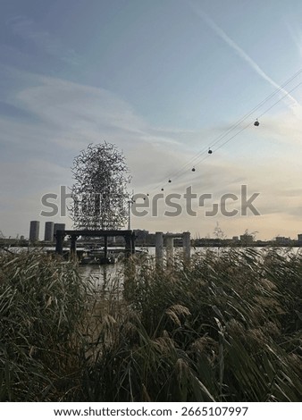 View of The Quantum Cloud, artwork by Anthony Gormley, from the banks of the River Thames at Greenwich Peninsula, London, UK. August 2025.