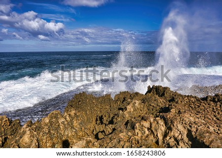 View of Quobba  blow holes in Western Australia.Powerful ocean swells force water through sea caves and up out of narrow holes in the rocks, jets of water erupt into the air