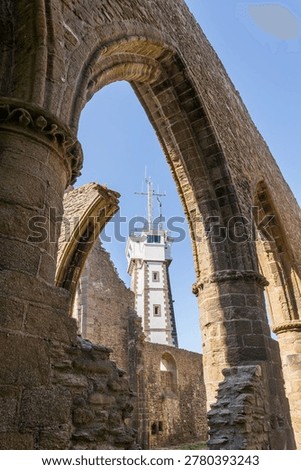 View of radar tower framed by Gothic stone arches of medieval abbey ruins at Pointe Saint‑Mathieu Plougonvelin Finistere Brittany France showing contrast between ancient architecture and modern maritime structure