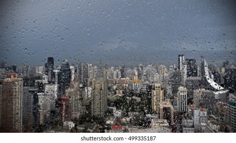 View of Rain Drops on a Window of a High Rise Building - Powered by Shutterstock