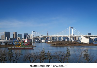 View from Odaiba（お台場）including Rainbow bridge, Olympic Rings（五輪）, and Tokyo Tower in Tokyo, Japan. December 31, 2020.