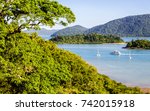 View from rainforest toward Shute Harbour, islands and Conway National Park, from Shute Haven, The Whitsundays, Queensland. Natural harbour, gateway to the Great Barrier Reef, 74 tropical islands.

