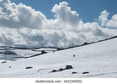 View Of Rallarvegen With Bikers On Snow. Famous Bicycle Trail On Hardangervidda Plateau Leads You Along The Bergen Railway Line From Haugastøl To Flåm. Norway