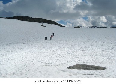 View Of Rallarvegen With Bikers On Snow. Famous Bicycle Trail On Hardangervidda Plateau Leads You Along The Bergen Railway Line From Haugastøl To Flåm. Norway