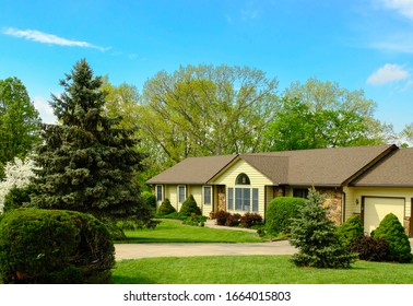 View Of Ranch Style House In Suburban Neighborhood In Missouri, Midwest, On Sunny Spring Day; View From The Street