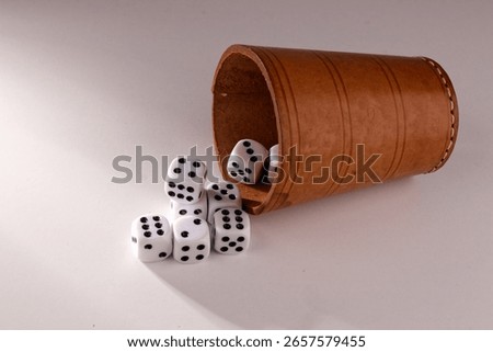 View of randomly positioned dice and a puzzle cup after a dice roll