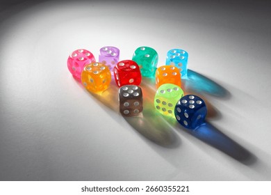 View of randomly positioned multicolored dice with light and real shadows