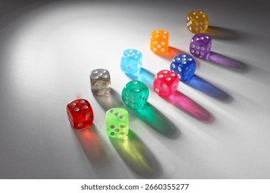 View of randomly positioned multicolored dice with light and real shadows