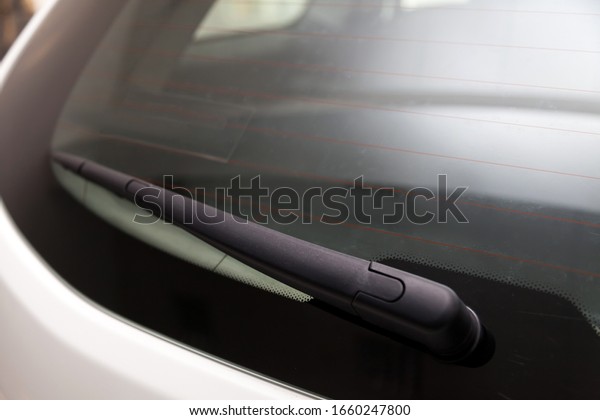 View to the rear window wiper\
that remove the melted snow and dirt from the windshield of the car\
during the day during the snow and rain. Auto service and\
parts.