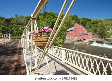 A view of the Red Mill through the Main St. Bridge in Clinton, New Jersey on a summer day.