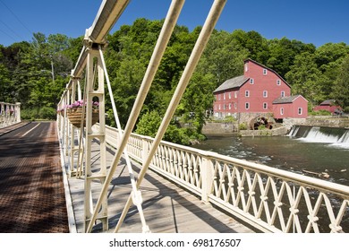 A view of the Red Mill through the Main St. Bridge in Clinton, New Jersey on a summer day.