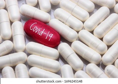 view a red pill word - COVID-19 with many white pills, close up. Medical concept of Virus Pandemic Protection, Coronavirus COVID-19

 - Shutterstock ID 1696245148