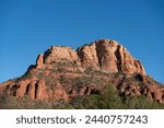View of red rock bluffs in Sedona, Arizona desert landscape during sunny day