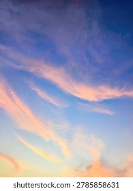 A view of reddish clouds as the sun rises over a dense urban area.