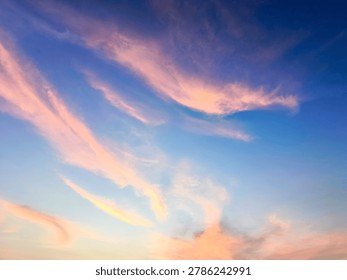 A view of reddish clouds as the sun rises over a dense urban area.