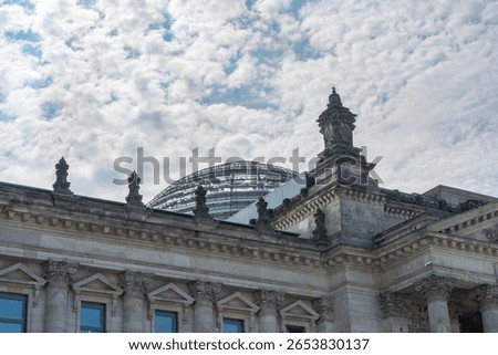 View of the Reichstag dome with a dramatic sky. Architecture meets modern transparency.