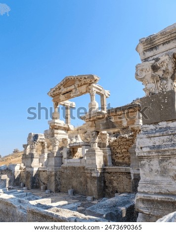 View of the remaining architectural elements and sculptures on the main street in the ancient city of Ephesus on a summer day in Izmir province, Turkey. 